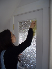 Janeen putting decorative film on back door