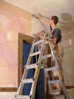 mathew putting plaster on the wall above the door